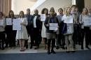 United Nations staff, some holding signs, stand in a silent protest against a U.N. meeting to designate Wonder Woman as an "Honorary Ambassador for the Empowerment of Women and Girls," Friday, Oct. 21, 2016 at U.N. headquarters. (AP Photo/Bebeto Matthews)