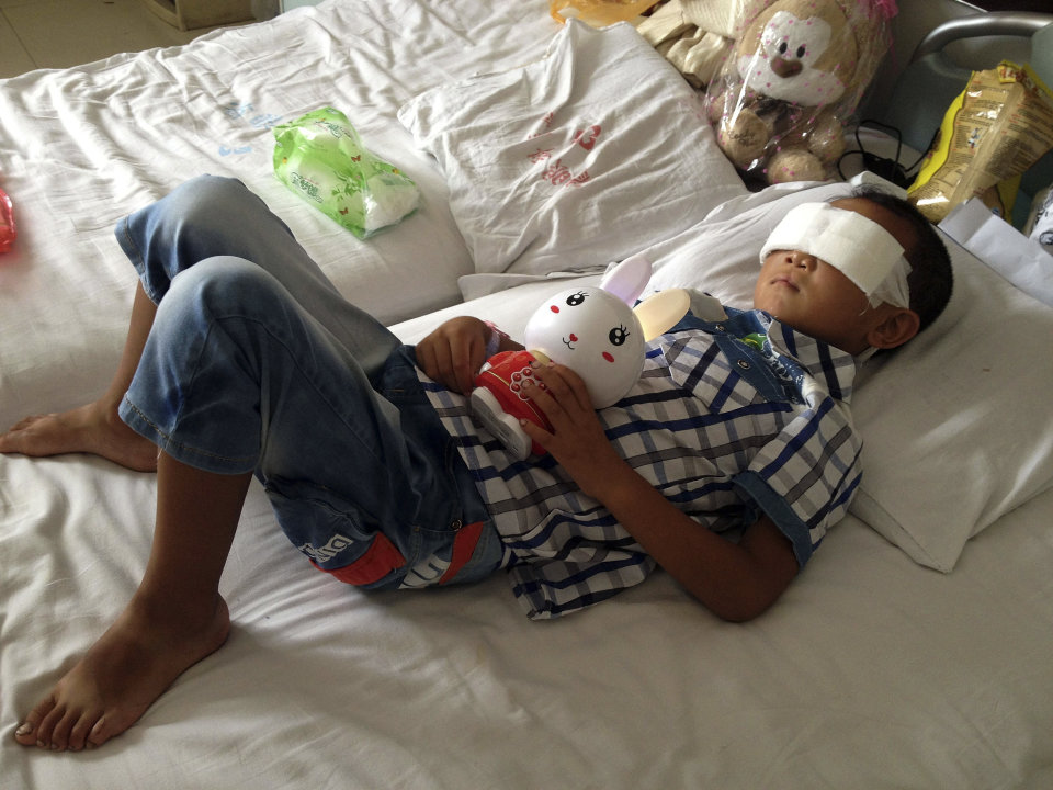 Guo Bin recuperates from an attack in the rural area of Linfen city that left him blind, in a hospital in Taiyuan in northwest China's Shanxi province on Wednesday, Aug. 28, 2013. A woman tricked the 6-year-old boy into going into a field, and then gouged out his eyes, police said Wednesday. (AP Photo) CHINA OUT
