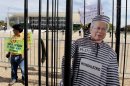 A life size image of Jose Dirceu, former chief of staff for former President Luiz Inacio Lula da Silva, stands inside a mock prison cage placed by protesters outside the Supreme Court in Brasilia, Brazil, Wednesday, Sept. 18, 2013. Demonstrators are protesting after the court accepted the appeal of some defendants, including Dirceu, who were found guilty in the nation's biggest political corruption case. The scandal saw top aides of Lula paying off legislators to support the ruling party's measures in congress. (AP Photo/Eraldo Peres)