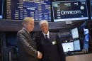 Omnicom Chief Executive John Wren and Publicis Group Chairman and CEO Maurice Levy shake hands after announcing an agreement on their merger on the floor of the New York Stock Exchange