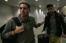 U.S. journalist Greenwald walks with his partner Miranda in Rio de Janeiro's International Airport