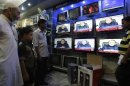 People watch Prime Minister of Pakistan Nawaz Sharif addressing the nation, at an electronic shop in Karachi, Pakistan, Monday, Aug. 19, 2013. Sharif has reiterated his offer to talk with militants who have so far rejected the prospect of negotiations. But he also held open the possibility of new military operations against militants who have waged a campaign of bombings and shootings that have killed thousands of civilians and security personnel. (AP Photo/Fareed Khan)