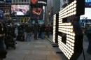 New Year's Eve "15" numerals stand lit on the sidewalk after they were unloaded from a truck in Times Square in New York