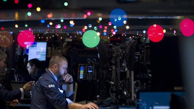 Trader Kevin Lodewick works on the floor of the NYSE, which has been decorated with Christmas lights, in New York