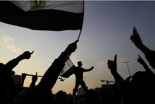 Egyptian protesters wave their national flags and chant slogans against the ruling military council at Tahrir Square, the focal point of the Egyptian uprising in Cairo, Egypt, Monday, Nov. 21, 2011. Security forces fired tear gas and clashed Monday with several thousand protesters in Cairo's Tahrir Square in a sustained challenge to the rule of Egypt's military regime. (AP Photo/Amr Nabil)