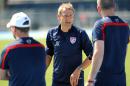 U.S.head coach Jurgen Klinsmann talks with his assistant coaches before the practice begins, Wednesday, June 4, 2014 in Jacksonville, Fla.. The team was practicing in advance of Saturday's friendly match against Nigeria, the last before the World Cup matches in Brazil. (AP Photo/The Florida Times-Union, Bob Mack)