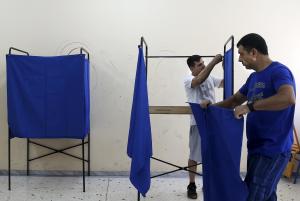Men prepare voting booths ahead of the referendum at &hellip;