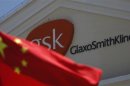 A Chinese national flag is seen in front of a GlaxoSmithKline office building in Shanghai