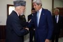 U.S. Secretary of State John Kerry, right, is greeted by Afghanistan's President Hamid Karzai as he arrives for a dinner at the presidential palace in Kabul, Afghanistan, Friday, July 11, 2014. Kerry visited Afghanistan in hopes of diffusing a crisis over the runoff presidential election to find a successor for outgoing President Karzai. (AP Photo/Jim Bourg, Pool)