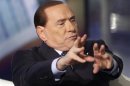 Italy's former Prime Minister Berlusconi gestures as he appears as a guest on the RAI television show Porta a Porta in Rome