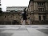 Woman walks past the Bank of Japan headquarters in Tokyo
