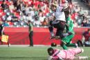 Germany's Anja Mittag jumps over Ivory Coast goalkeeper Dominique Thiamale as they watch the ball enter the goal during a Group B match at the 2015 FIFA Women's World Cup at Landsdowne Stadium in Ottawa on June 7, 2015