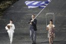 Greece's flag bearer Alexandros Nikolaidis holds the national flag as he leads the contingent in the athletes parade during the opening ceremony of the London 2012 Olympic Games at the Olympic Stadium