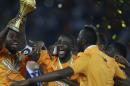 Ivory Coast's Yaya Toure, center, holds up the trophy with teammates after winning the African Cup of Nations final soccer match against Ghana in Bata, Equatorial Guinea, Sunday, Feb. 8, 2015. (AP Photo/Sunday Alamba)