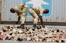 KWS officers count elephant tusks at a container terminal in Mombasa
