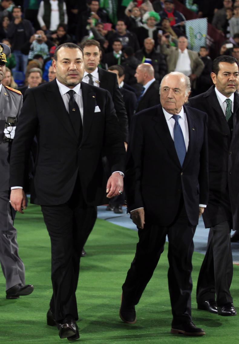 Morocco's King Mohammed VI arrives with FIFA President Blatter to watch the 2013 FIFA Club World Cup final soccer match between Morocco's Raja Casablanca and Germany's Bayern Munich at Marrakech stadium