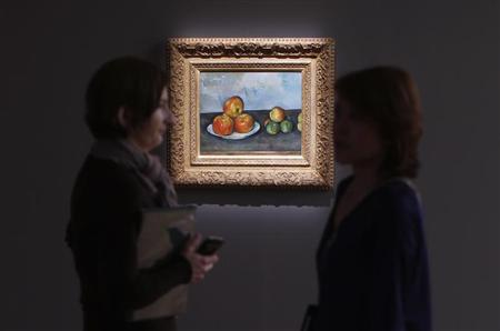 Visitors talk near Paul Cezanne's 'Les Pommes,' estimated between $25-35 million, during a preview of Sotheby's May 7 Impressionist and Modern Art Evening Sale at Sotheby's in New York, May 3, 2013. REUTERS/Mike Segar