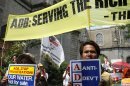 Protesters display placards during a rally coinciding with the 45th Annual Meeting of the Board of Governors of the Asian Development Bank Wednesday, May 2, 2012, in Manila, Philippines. The protesters were rallying against the bank's alleged role in the privatization of energy and water sectors and in pushing coal and other dirty technologies in Asia and the Pacific. (AP Photo/Pat Roque)