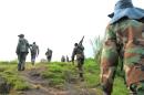 Fighters of the M23 rebel group walk on June 3, 2013 in Mutaho, about 15 kms from the eastern Democratic Republic of Congo city of Goma