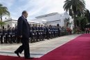 Algeria's President Bouteflika walks towards Spain's PM Rajoy during a welcoming ceremony at the presidential palace in Algiers