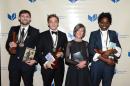 The National Book Award winners, from left: Phil Klay, fiction; Evan Osnos, non-fiction; Louise Gluck, poetry and Jacqueline Woodson, young people's literature pose with their award while attending the 65th Annual National Book Awards on Nov. 19, 2014 at Cipriani Wall Street in New York City. (AP Photo/National Book Foundation, Robin Platzer)