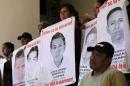 Relatives hold up posters of some missing students from Ayotzinapa Teacher Training College during a news conference, at the Miguel Agustin Pro Juarez Human Rights Center in Mexico City