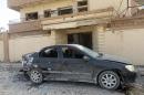 A car damaged by an explosion is pictured in Benghazi