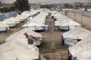 FILE - in this Sept. 16, 2015 file photo, rows of tents at a refugee camp in Baghdad's western neighborhood of Ghazaliyah, Iraq. The camp accommodating people from Anbar province's Ramadi and around received humanitarian aid. A summer of stalemate in the effort to reclaim the Iraqi provincial capital of Ramadi, despite U.S.-backed Iraqi troops vastly outnumbering Islamic State fighters, calls into question not only Iraq's ability to win a test of wills over key territory but also the future direction of Washington's approach to defeating the extremist group. (AP Photo/Hadi Mizban, File)
