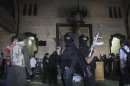 Policemen stand guard inside room of al-Fath mosque when supporters of deposed President Mursi exchanged gunfire with security forces inside mosque in Cairo