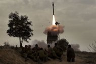 Israeli soldiers watch as a missile is launched from the Iron Dome defence system in the southern Israeli city of Beer Sheva in March 2012. Israel on Sunday began testing an SMS system for warning the public of an imminent missile attack as chatter over a possible strike on Iran dominated the Israeli press headlines. (AFP Photo/Menahem Kahana)