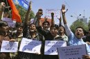 Indian supporters of Akhil Bharatiya Vidhyarthi Parishad (ABVP) or All India Student Council hold placards and shouts slogans against the alleged incursion by Chinese troops into Indian territory, during a protest in Ahmadabad, India, Wednesday, May 1, 2013. India said around 50 Chinese troops crossed the de facto border between the countries and went 19 kilometers (12 miles) into Indian territory on April 15 and are camping in tents in Ladakh in the eastern part of Indian-administered Kashmir. (AP Photo/Ajit Solanki)