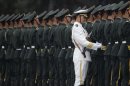 A member of the People's Liberation Army's navy guard of honour adjusts military uniforms in Beijing