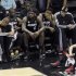 Miami Heat's LeBron James sits with his teammates near the end of their loss to the San Antonio Spurs in Game 5 of their NBA Finals basketball series in San Antonio