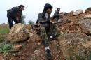 Fighters from the Al-Nusra Front, Al-Qaeda's Syria branch, hold a position as they fight against forces loyal to the regime on December 19, 2014, in the southern countryside of Syria's northern city of Aleppo