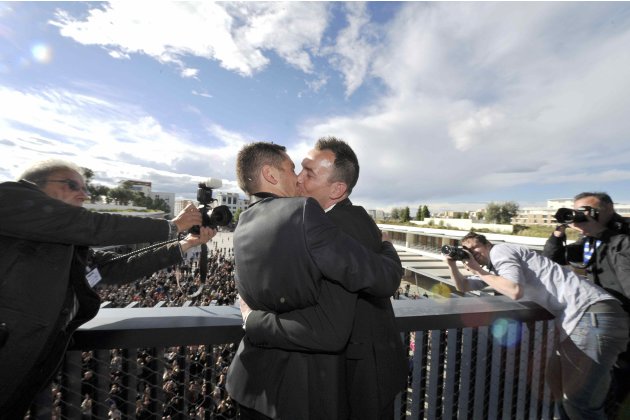 Autin and Boileau kiss on the balcony in front of the crowd after their marriage at the city hall