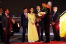 U.S. President Barack Obama receives flowers as he arrives at Noibai International Airport in Hanoi, Vietnam