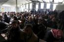 Syrian refugees wait to register at the UNHCR office in Amman