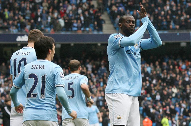 Manchester City's Yaya Toure (R) celebrates after scoring during their Premier League match against Southampton at the Etihad Stadium on April 5, 2014