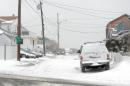 Snow begins to accumlutate along Otis Street January 2, 2014 in Winthrop, Massachusetts