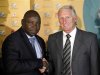 SAFA president Kirsten Nematandani congratulates Gordon Igesund, the new head coach of the South African national soccer team after the announcement in Johannesburg