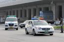 File photo shows an ambulance (L) following a police car at Incheon International Airport, west of Seoul, on July 30, 2007
