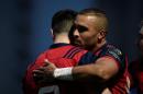Munster Rugby's fullback Simon Zebo (R) is congratulated by teammates after scoring a try during the European Champions Cup rugby union match between Racing 92 and Munster Rugby, on January 7, 2017
