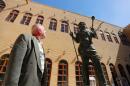An Iraqi looks at a statue during his visit to the Najaf Heritage and 1920 Revolution Museum in the Khan al-Shilan building on February 27, 2014 in the holy city of Najaf, central Iraq