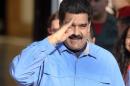 Venezuelan President Nicolas Maduro salutes during a rally at Miraflores presidential palace in Caracas on March 8, 2016