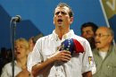 Venezuela's opposition leader and presidential candidate Capriles sings the national anthem during a campaign rally in Caracas