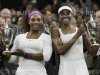 Venus Williams of the U.S. and Serena Williams of the U.S. hold their trophies after defeating Andrea Hlavackova of the Czech Republic and Lucie Hradecka of the Czech Republic in their doubles tennis match at the Wimbledon tennis championships in London
