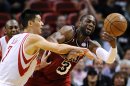 Houston Rockets' Lin fouls Miami Heat's Wade during their NBA basketball game in Miami