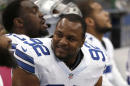 In this Oct. 5, 2014 file photo, Dallas Cowboys defensive end Jeremy Mincey sits on the bench during an NFL football game against the Houston Texans, in Arlington, Texas. Mincey came to Dallas as the "old man" on the defensive line after an unhappy ending in Jacksonville, where he grew up as an NFL player. He's still looking forward to seeing and playing against some old friends in London, though. (AP Photo/Brandon Wade, File)