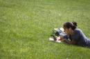 A woman lies in the grass at Columbia University in New York