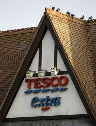 A sign of Tesco supermarket is seen at a branch in Purley, south London, Wednesday, Jan. 16, 2013. The Irish food safety watchdog said Tuesday that it had discovered traces of horse and pig DNA in burger products sold by some of the country's biggest supermarkets. Tesco that authorities said was made of roughly 30 percent horse. Tesco, the country's biggest supermarket chain, took out full-page newspaper ads Thursday Jan. 17, 2013 to apologize for an unwanted ingredient in some of its hamburgers: horsemeat. Ten million burgers have been taken off shop shelves after the revelation that beef products from three companies in Ireland and Britain contained horse DNA. Most had only small traces, but one type of burger sold by Tesco was 29 percent horse. The contrite grocer told customers that "we and our supplier have let you down and we apologize." [AP Photo/Sang Tan)